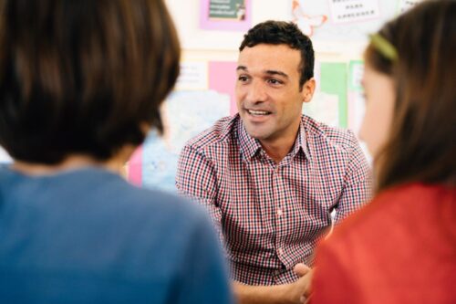 Man in gesprek met kinderen min min min